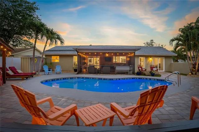 a view of a house with a backyard porch and sitting area