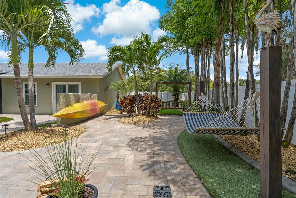 808 Rustic Oaks Drive Palm Harbor, FL 34684 - Photo 48 of 55 a view of a chair and table in backyard