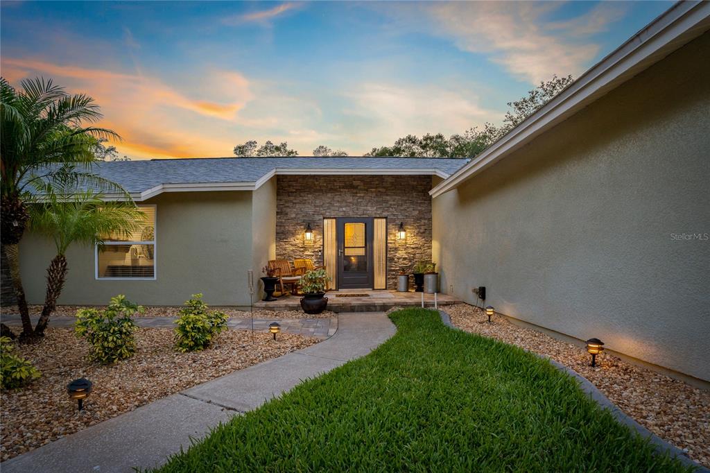 808 Rustic Oaks Drive Palm Harbor, FL 34684 - Photo 49 of 55 a view of a house with a patio