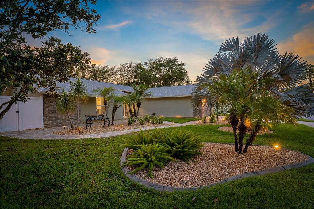 808 Rustic Oaks Drive Palm Harbor, FL 34684 - Photo 51 of 55 a view of a house with a backyard porch and sitting area