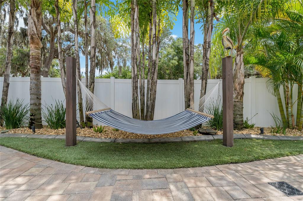 808 Rustic Oaks Drive Palm Harbor, FL 34684 - Photo 53 of 55 a view of a fountain in the yard with palm trees