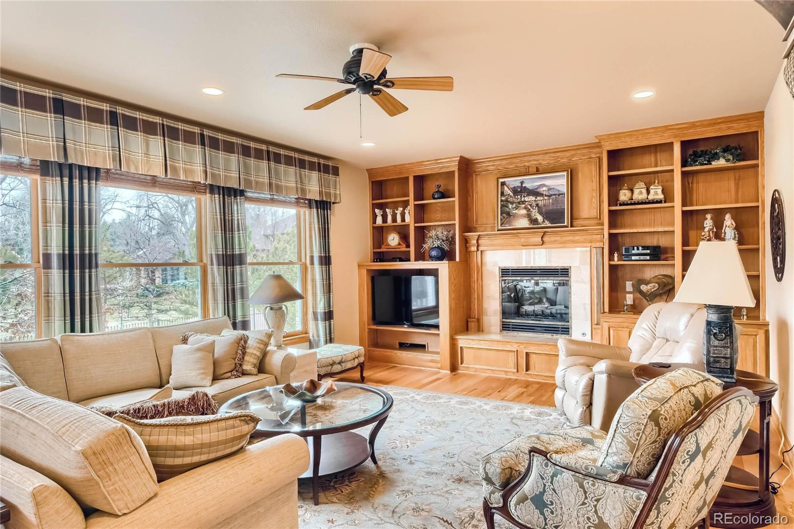 3935 Pierson Street Wheat Ridge, CO 80033 - Photo 12 of 40 a living room with furniture ceiling fan and a window