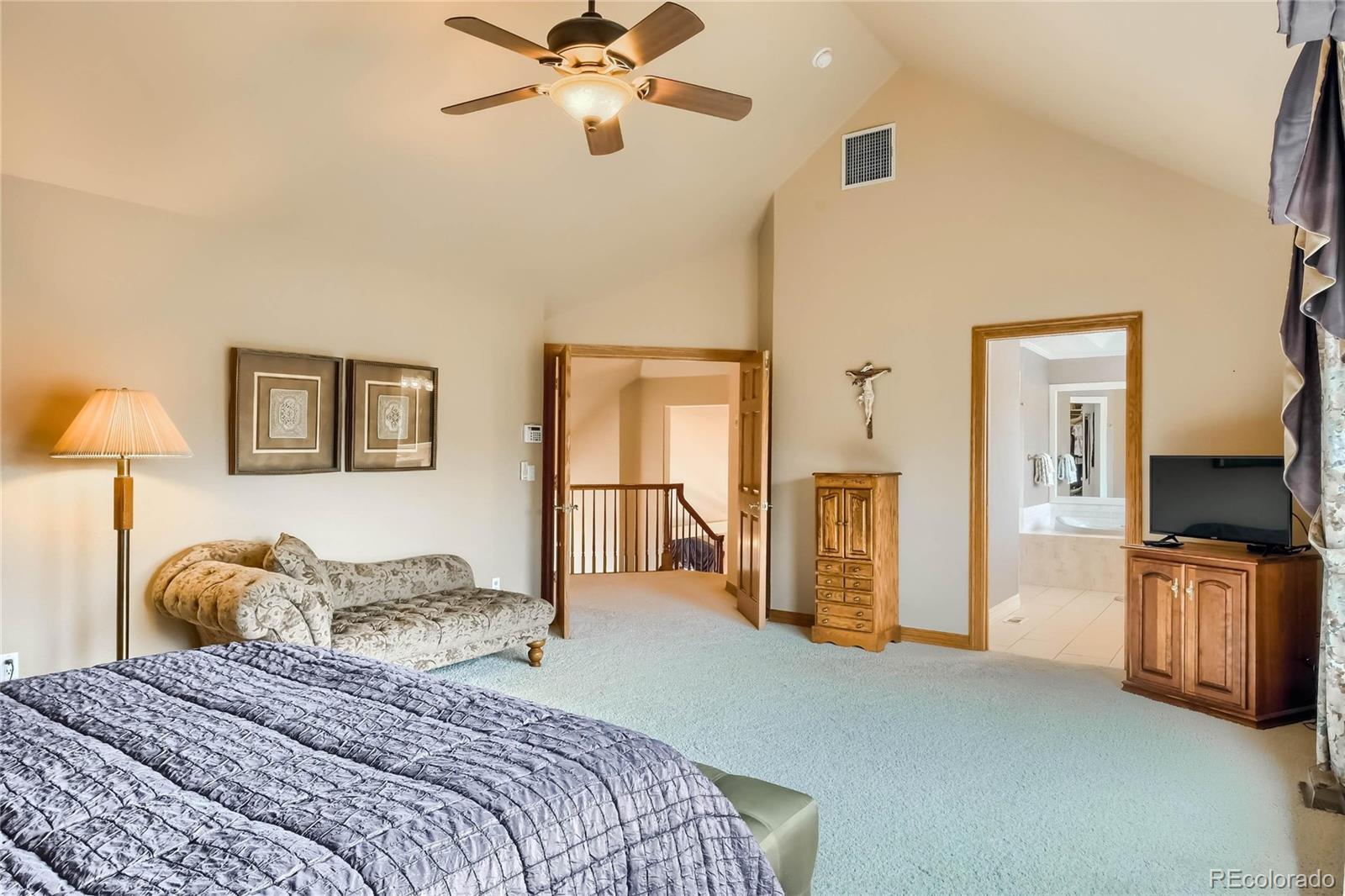 3935 Pierson Street Wheat Ridge, CO 80033 - Photo 15 of 40 a bedroom with a bed and a chandelier