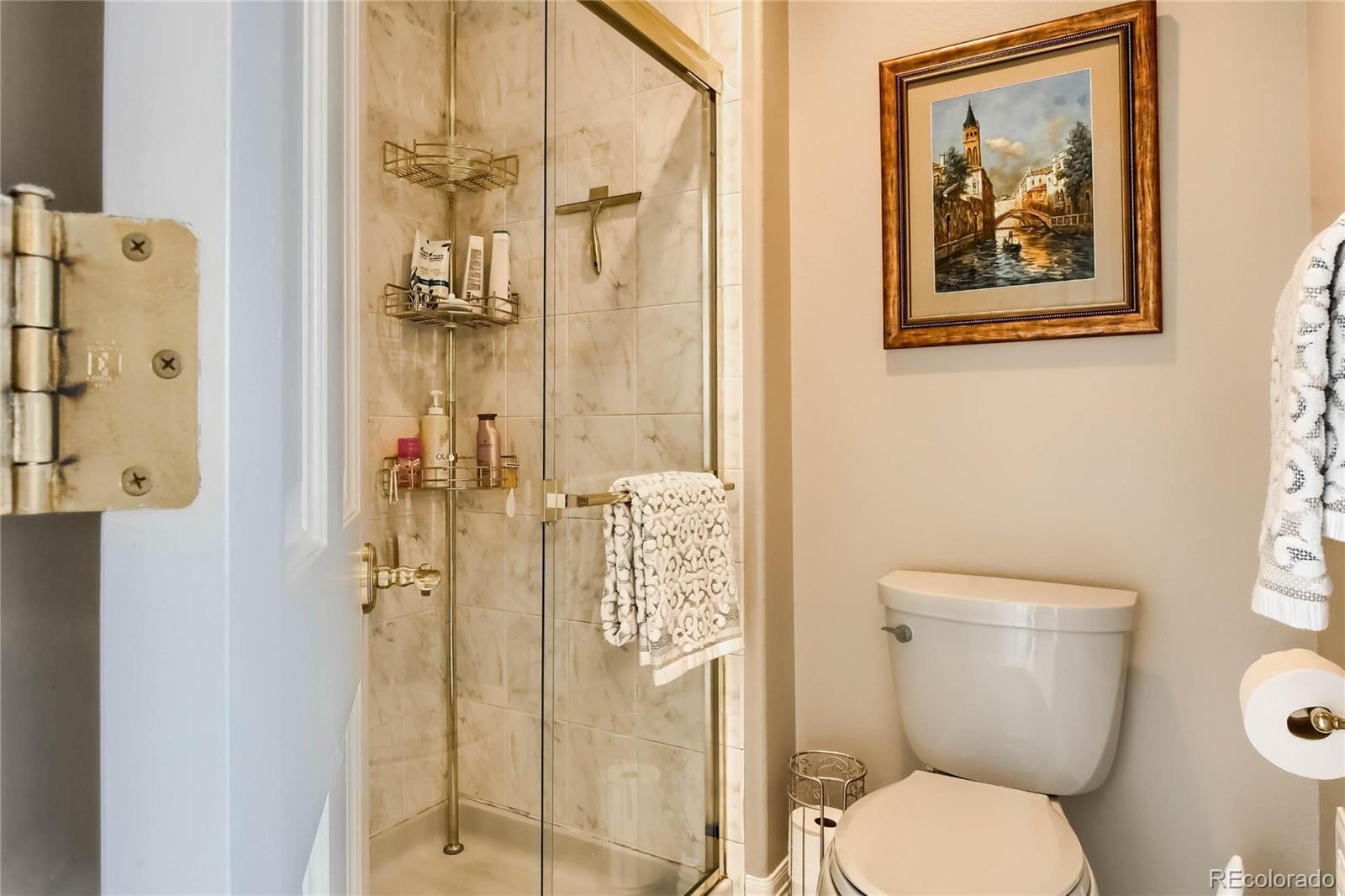 3935 Pierson Street Wheat Ridge, CO 80033 - Photo 17 of 40 a bathroom with a toilet and a shower