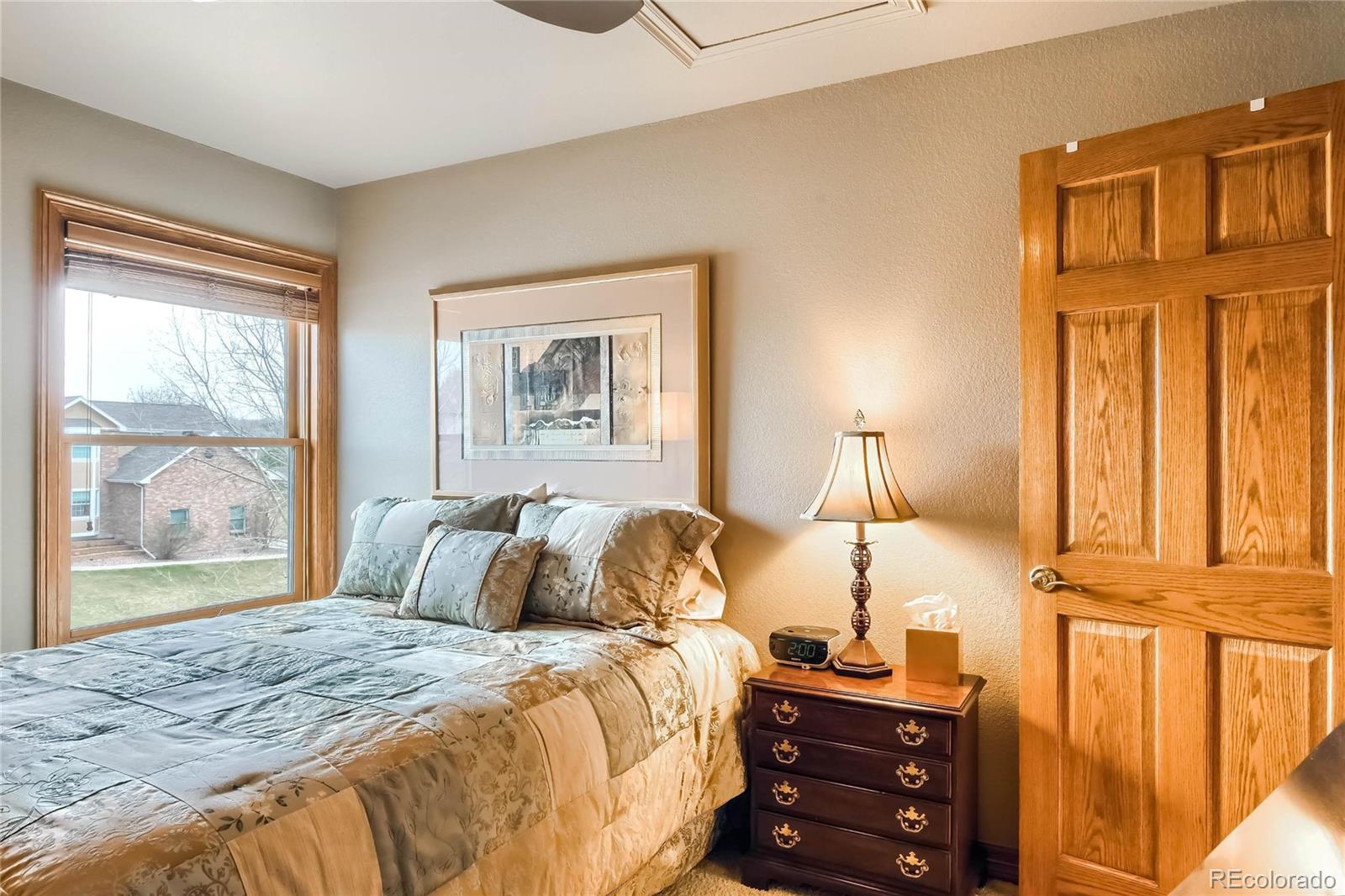 3935 Pierson Street Wheat Ridge, CO 80033 - Photo 19 of 40 a bedroom with a bed and wooden floor