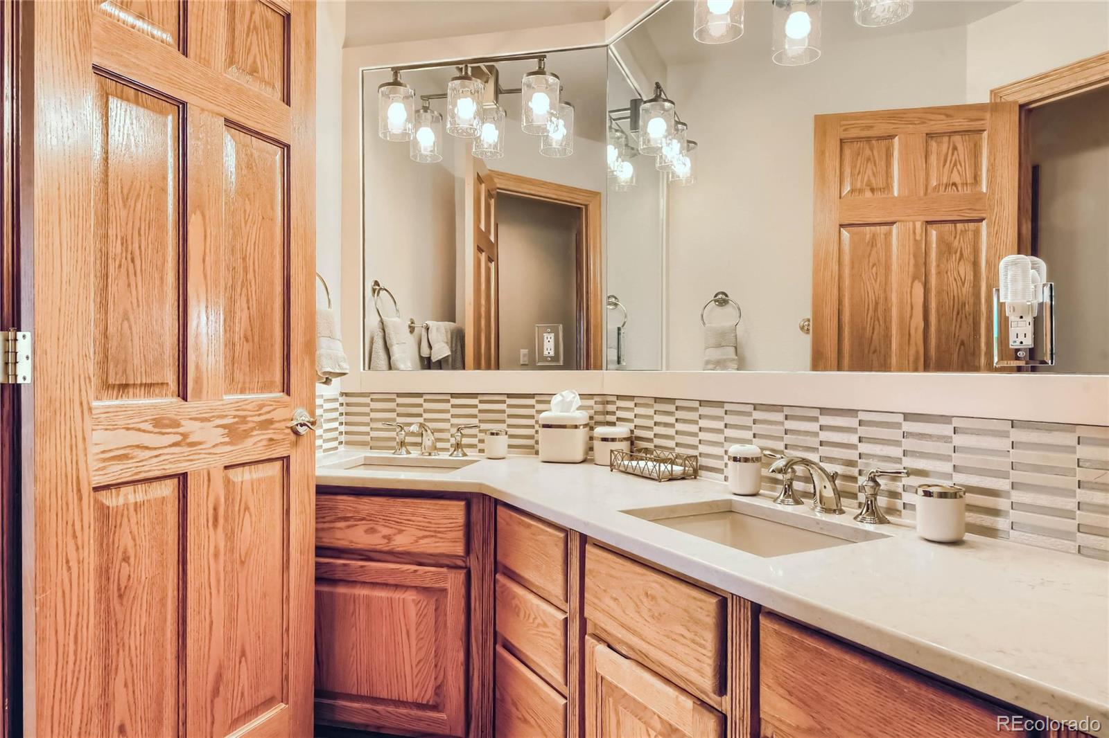 3935 Pierson Street Wheat Ridge, CO 80033 - Photo 20 of 40 a bathroom with a sink and a mirror