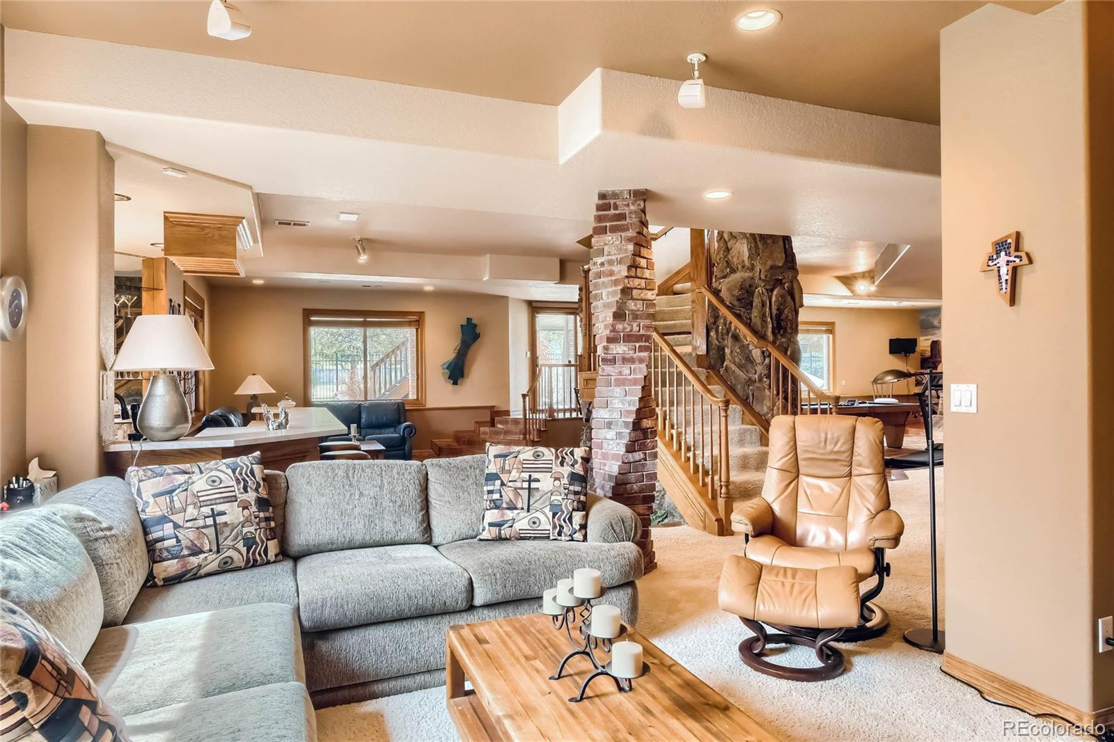 3935 Pierson Street Wheat Ridge, CO 80033 - Photo 25 of 40 a living room with furniture and a chandelier