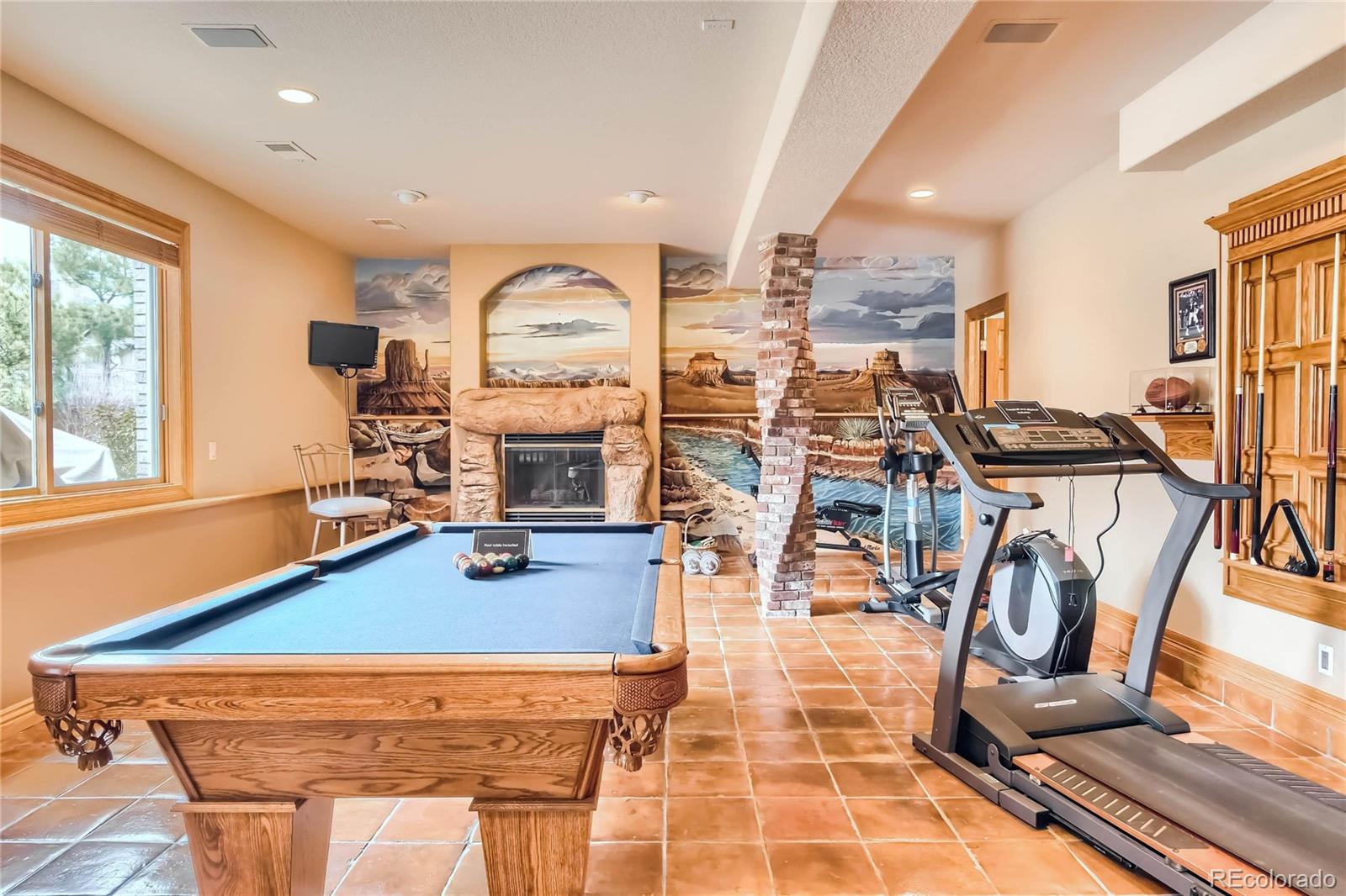 3935 Pierson Street Wheat Ridge, CO 80033 - Photo 27 of 40 a room with gym equipment and large windows