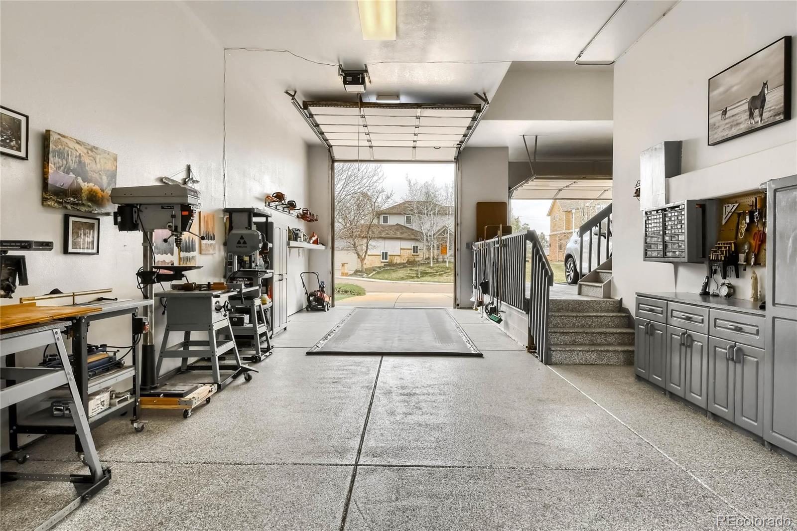3935 Pierson Street Wheat Ridge, CO 80033 - Photo 30 of 40 a kitchen with stainless steel appliances kitchen island granite countertop a refrigerator and a stove