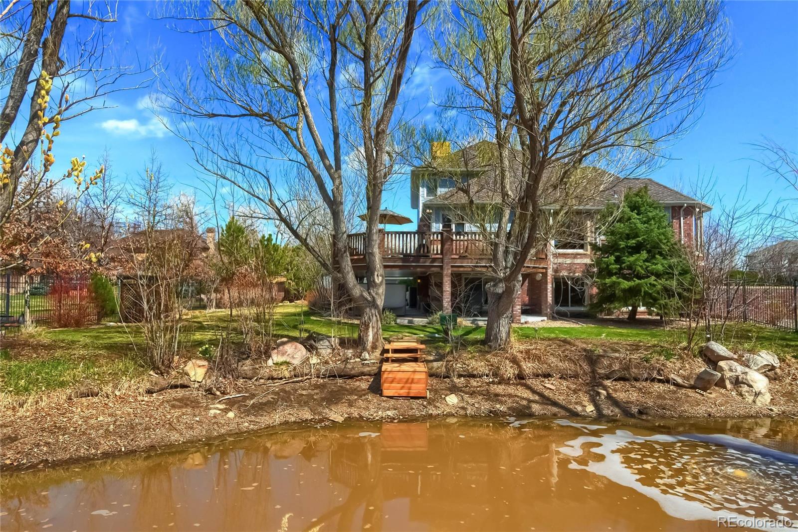 3935 Pierson Street Wheat Ridge, CO 80033 - Photo 36 of 40 a front view of a house with a yard and lake view