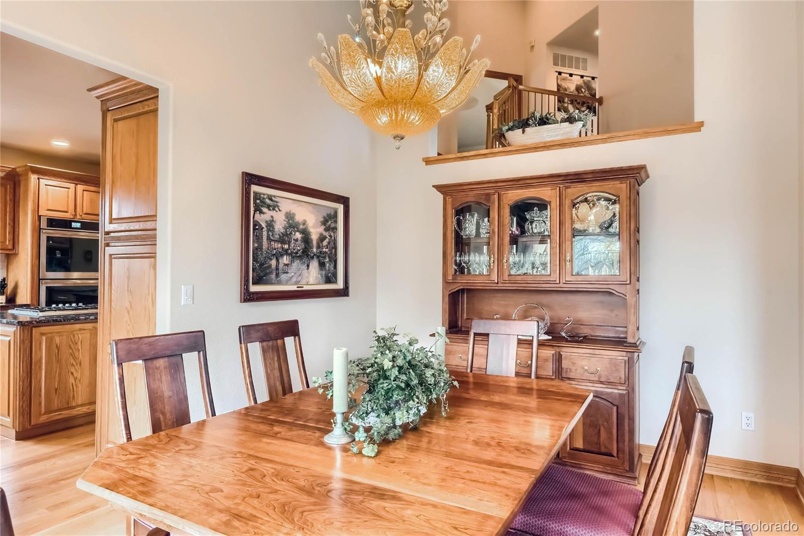 3935 Pierson Street Wheat Ridge, CO 80033 - Photo 7 of 40 a view of a dining room with furniture and wooden floor