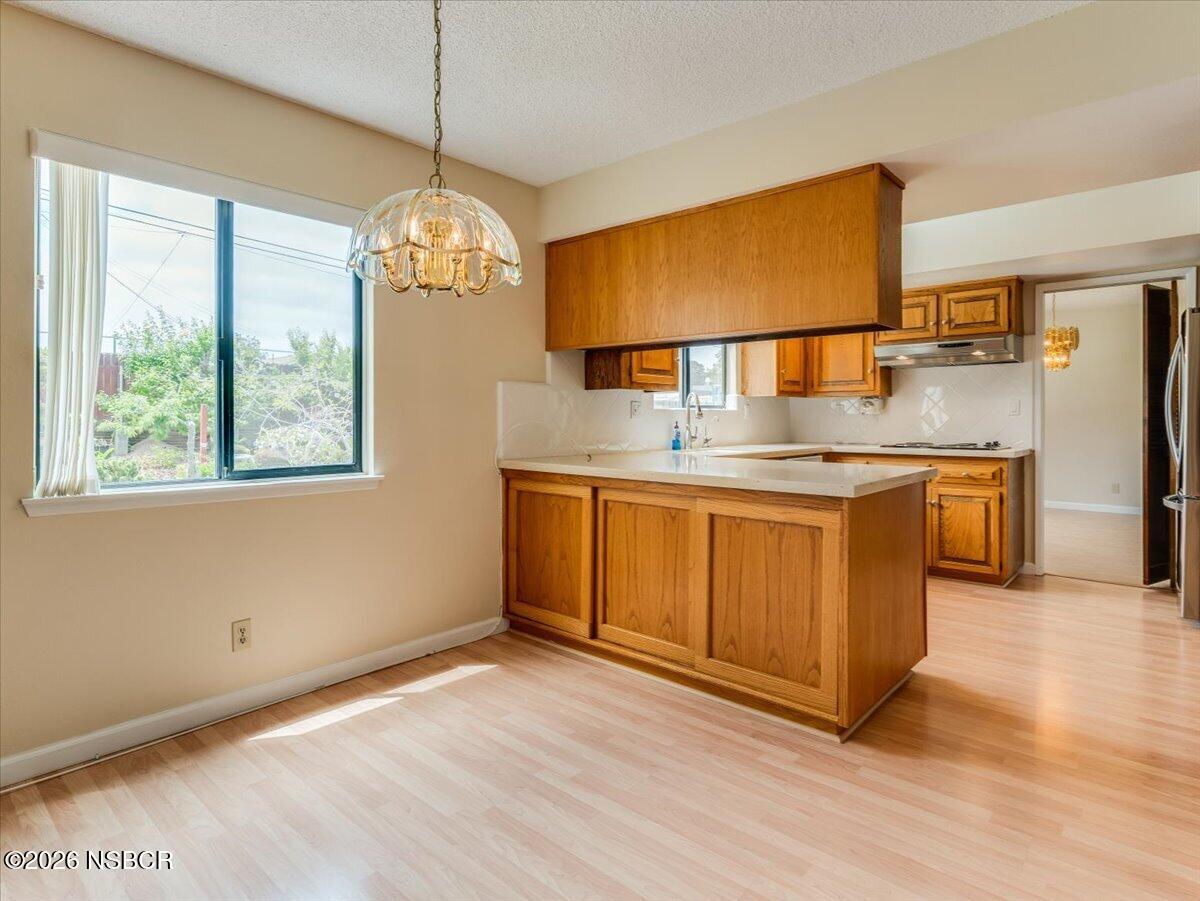 360 Tallyho Road Santa Maria, CA 93455 - Photo 25 of 72 a kitchen with stainless steel appliances granite countertop a sink a stove a refrigerator and island with wooden floor