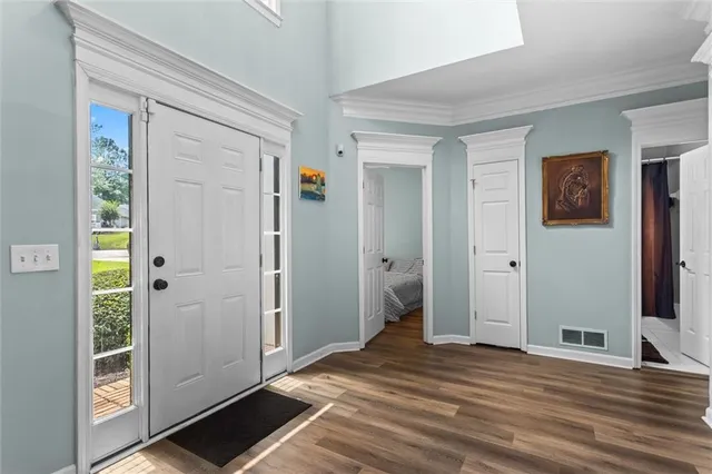 a kitchen with stainless steel appliances kitchen island a stove and a flat screen tv
