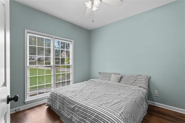 a kitchen with stainless steel appliances granite countertop a sink a stove a refrigerator and island with wooden floor