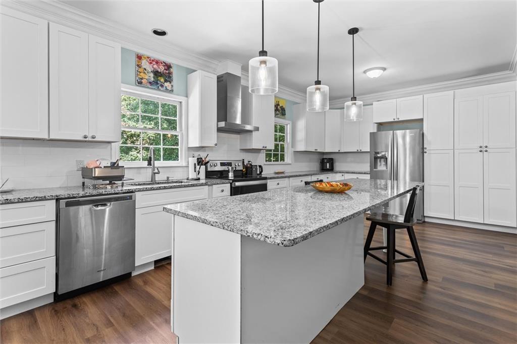 3183 Robinwood Trail Decatur, GA 30034 - Photo 16 of 61 a kitchen with stainless steel appliances granite countertop a sink a stove a refrigerator and island with wooden floor
