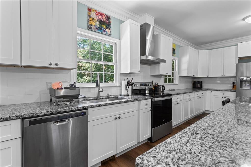 3183 Robinwood Trail Decatur, GA 30034 - Photo 17 of 61 a kitchen with stainless steel appliances granite countertop a sink dishwasher a stove a microwave oven and cabinets with wooden floor