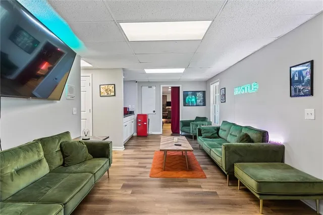 a view of a workspace with furniture and a window