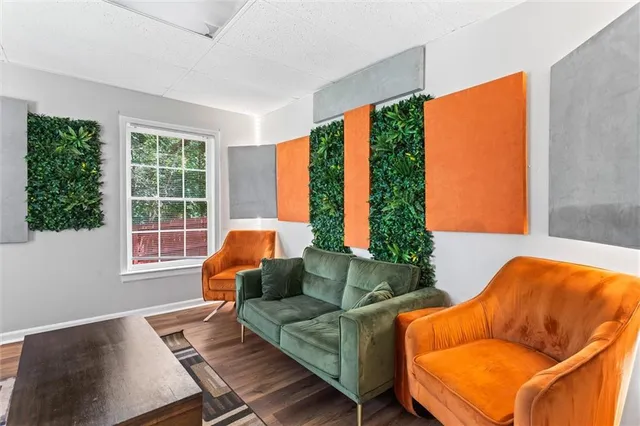 a view of a patio with table and chairs with wooden floor and fence