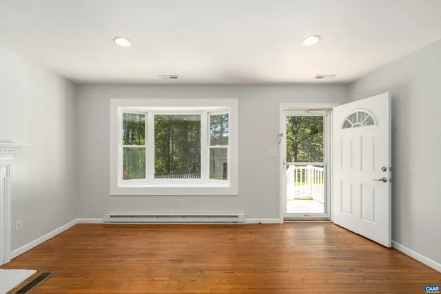 wooden floor in an empty room with a window