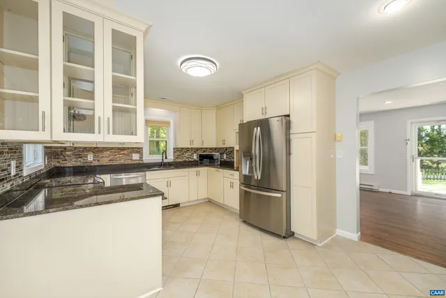 a kitchen with a refrigerator sink and cabinets