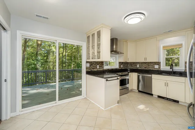 a kitchen with granite countertop a stove top oven sink and cabinets