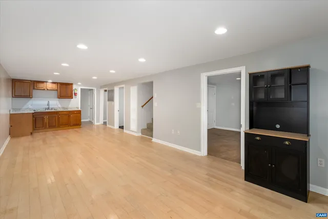 wooden floor in an empty room with kitchen