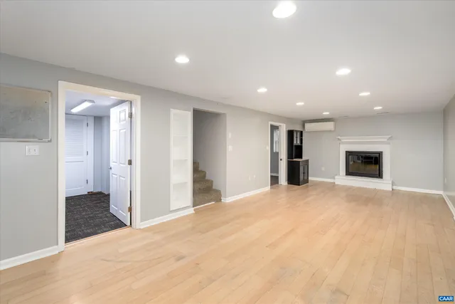 a view of empty room with a kitchen