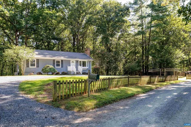 a view of a house with a yard patio and swimming pool