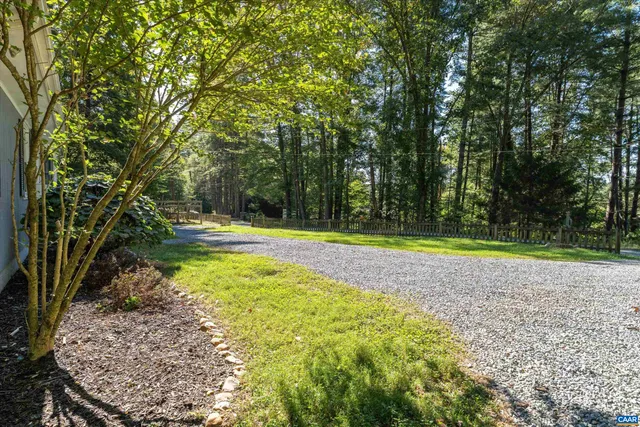 a view of a tennis ground with large trees