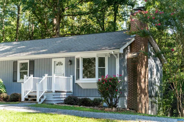 a front view of a house with a yard table and chairs
