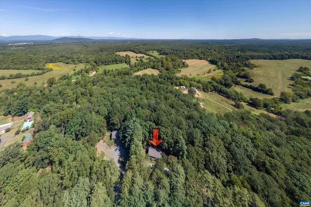 an aerial view of residential houses with outdoor space and river