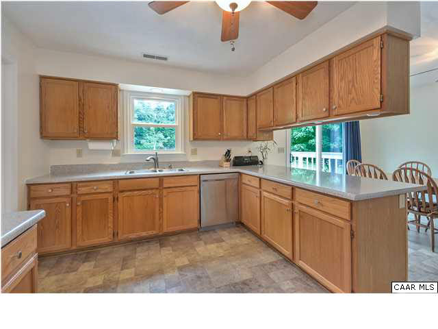 6 Spring Oaks Lane Ruckersville, VA 22968 - Photo 13 of 27 a kitchen with stainless steel appliances granite countertop a sink counter space cabinets and a large window