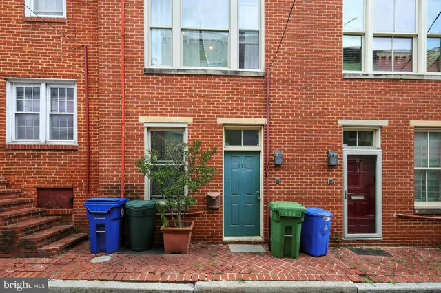 a view of a brick house with potted plants