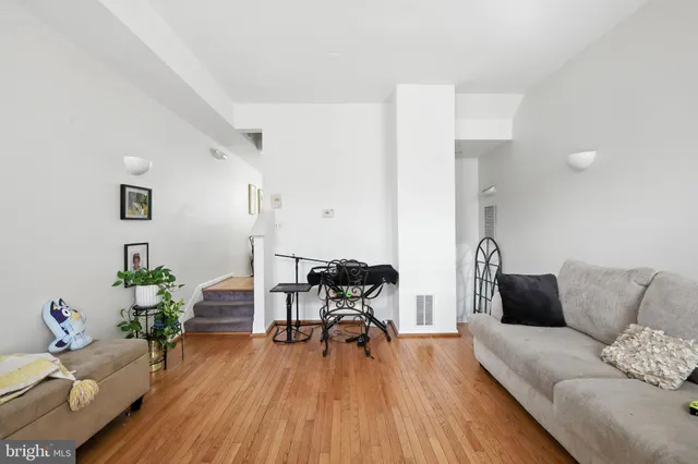 a kitchen with stainless steel appliances a white refrigerator a stove and a window