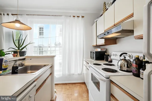 a kitchen with a table chairs and a stove