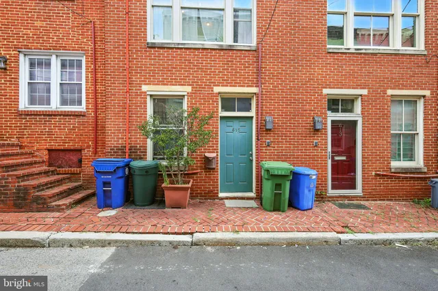 a view of a brick house with many windows