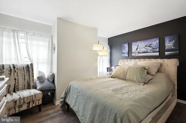 a bedroom with a bed and a painting on the wall