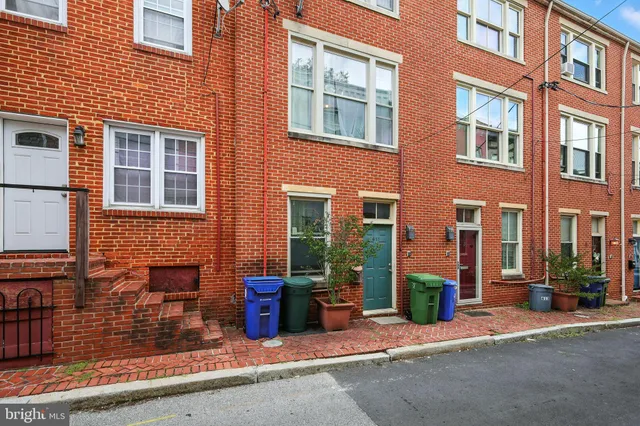 a front view of a brick building with many windows
