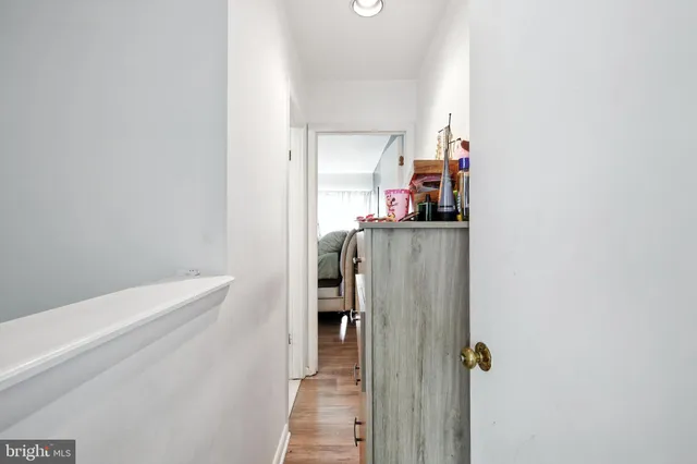 a view of a hallway with closet and natural light