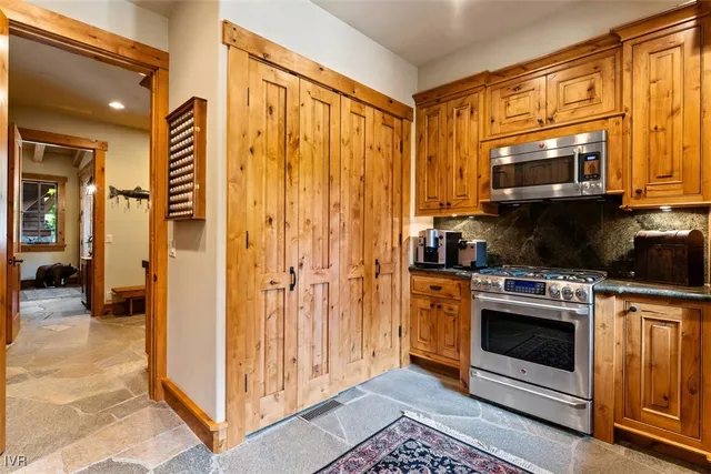 a kitchen with stainless steel appliances granite countertop a stove and a refrigerator
