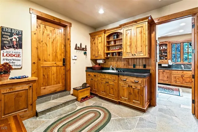 a spacious bedroom with a bed and wooden cabinets