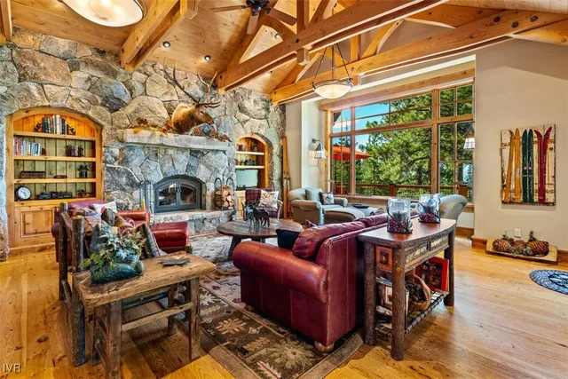 a living room with fireplace furniture and a large window