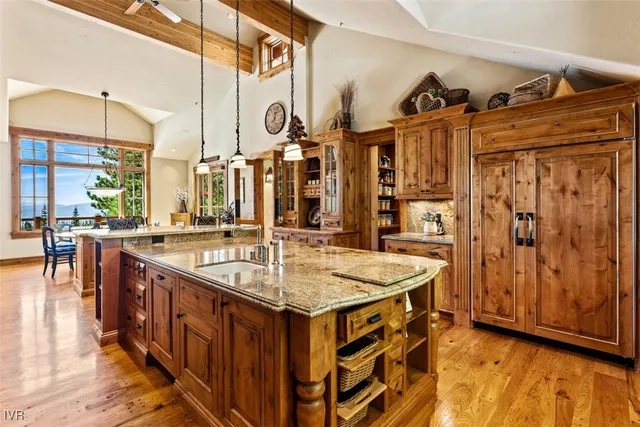 a kitchen with stainless steel appliances granite countertop a sink and a refrigerator