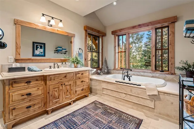 a spacious bathroom with double vanity and a bathtub
