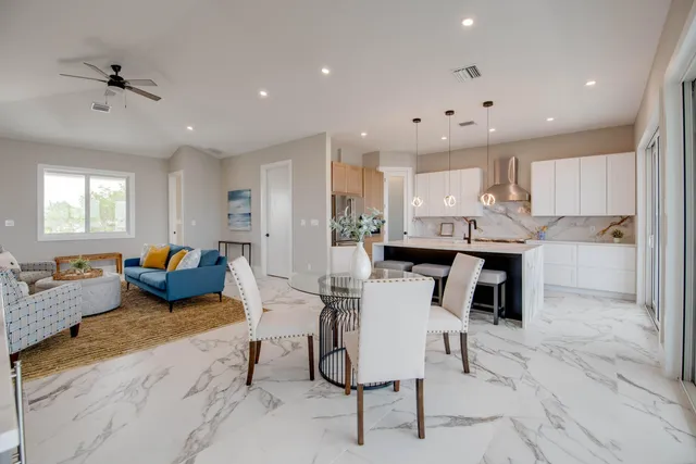 a living room with furniture and kitchen view