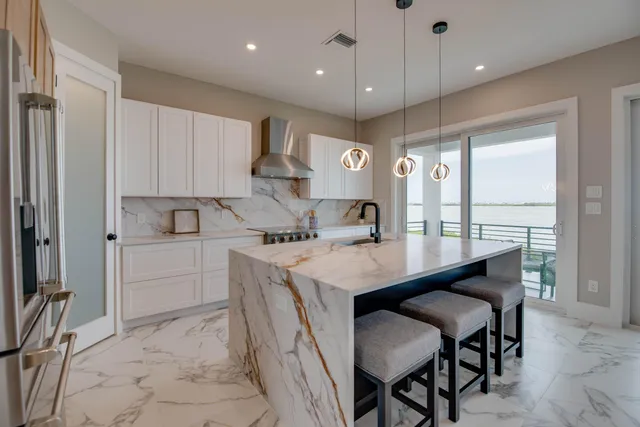 a kitchen with a table chairs sink and cabinets