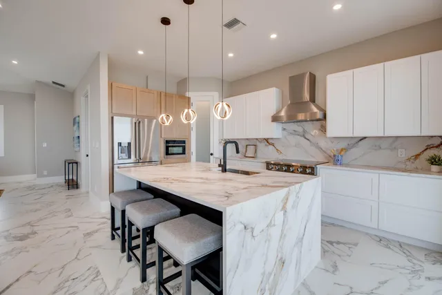 a kitchen with kitchen island a wooden floor and white cabinets