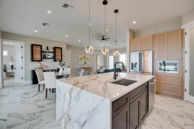 a kitchen with center island table and chairs