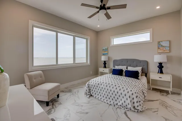 a bedroom with a large bed and a window