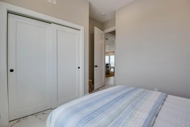 a bedroom with a bed and a mirror